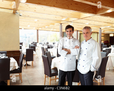Two proud chefs in a large restaurant Stock Photo