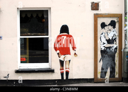 Banksy graffiti on the wall of the Prince Albert Pub in Brighton, the kissing policemen is a copy as the original has been sold Stock Photo