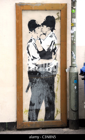 Banksy graffiti on the wall of the Prince Albert Pub in Brighton, the kissing policemen is a copy as the original has been sold Stock Photo