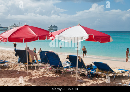 Cruise ship ocean liner near Brighton Beach or Cockspur Beach white sand umbrellas Barbados, Caribbean. Stock Photo