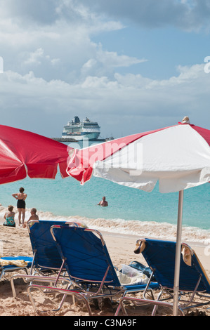 Cruise ship ocean liner near Brighton Beach or Cockspur Beach white sand umbrellas Barbados, Caribbean. Stock Photo