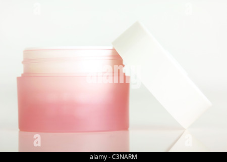 Lip balm in round box, closeup on white Stock Photo