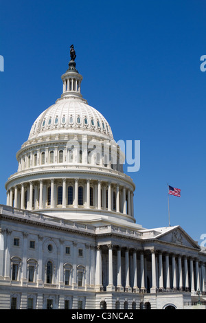 US Capitol dome and American waving flag in Washington DC with blue sky ...