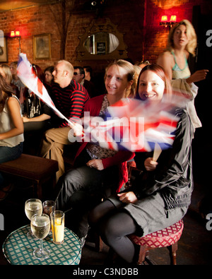 Two girls waving Union Flags while watching the Royal wedding in Brighton UK Stock Photo