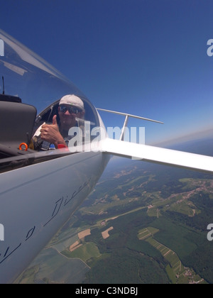 Happy glider pilot in flight over Lorraine region , France. Glider model's Duo-Discus. Stock Photo