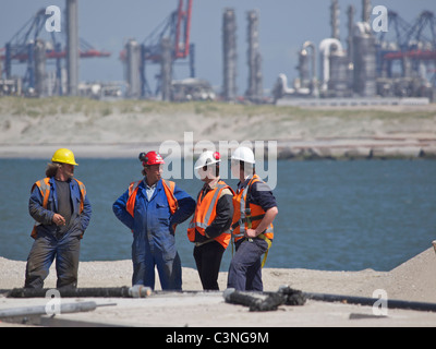 Men discussing their work in the port of Rotterdam, building the new Maasvlakte 2 area. the Netherlands Stock Photo