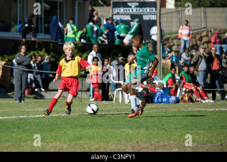 Young football players of an U13 team dribbling in a match Cape Town South Africa Stock Photo