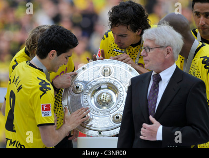 Borussia Dortmund player Nuri Sahin (left) and Mats Hummels ( right) caress the german Bundesliga football league trophy Stock Photo