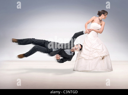 Bride abusing groom, isolated on white Stock Photo