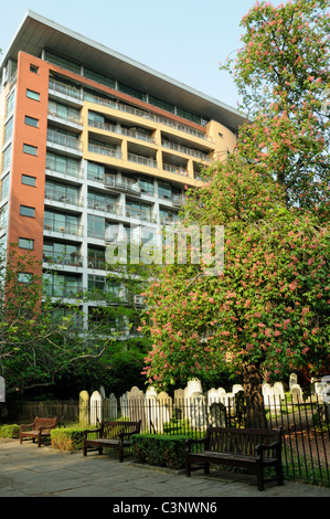 Bunhill Fields burial ground, gravestones with modern flats behind Islington but managed by the City of London England UK Stock Photo