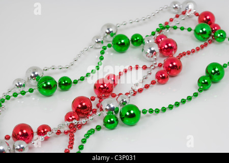 https://l450v.alamy.com/450v/c3p031/white-green-red-shiny-plastic-beads-on-white-background-c3p031.jpg