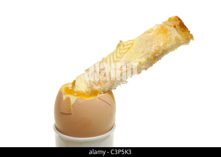 Soft boiled egg with a buttered toast soldier isolated against white Stock Photo