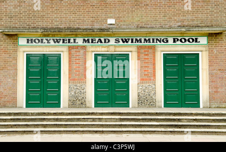 three closed green doors at the entrance and steps to Holymead Mead outdoor swimming pool High Wycombe Bucks UK Stock Photo
