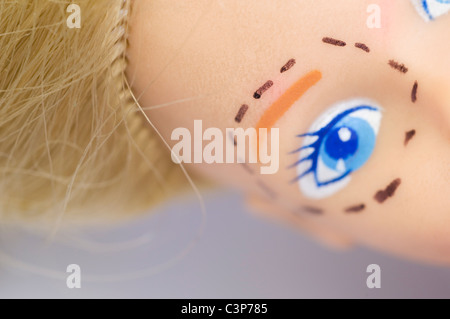 lifting markings on doll face Stock Photo