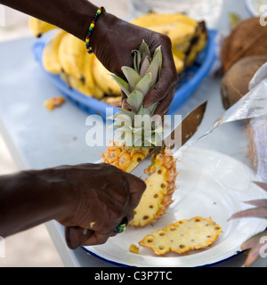 Serving Pineapple sliced on Long Bay Beach in Antigua Stock Photo