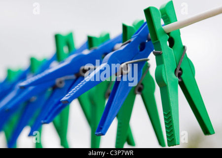 Plastic Clothes Pegs Hanging on a clothes Line Stock Photo