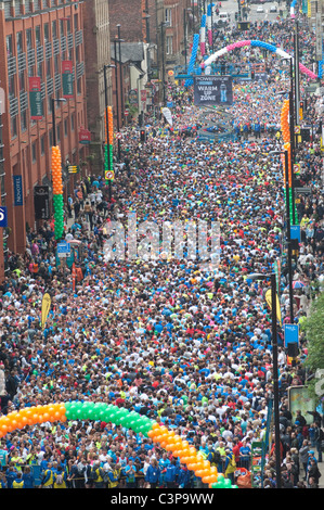 Participants in the Bupa Great Manchester Run take part in a mass warm up prior to the start of one of the races. Stock Photo