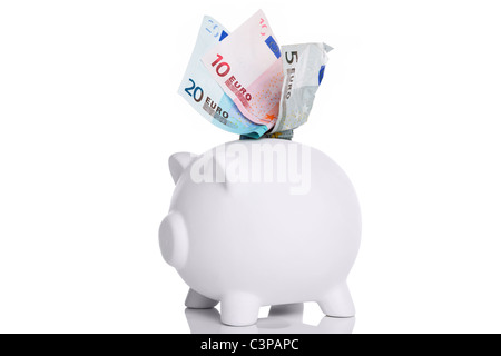 Photo of a white piggy bank with Euros in the slot cut out on a white background. Stock Photo
