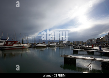 stormy bad weather clearing over marina harbour in the uk Stock Photo