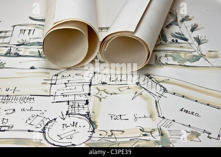 the blueprint of a house with two paper rolls Stock Photo