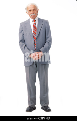 Full length portrait of an elder man standing over white. Stock Photo