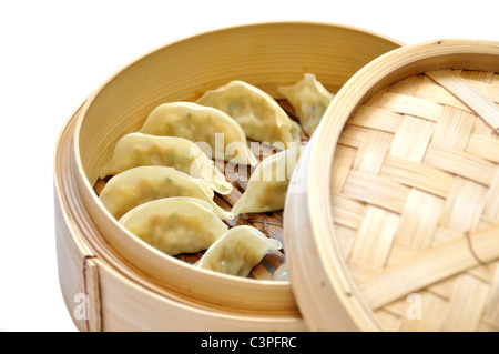 Dumplings in a dumpling steamer on a white background Stock Photo