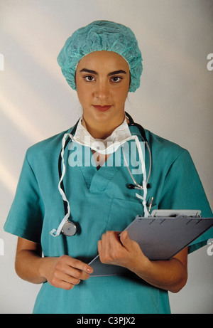 Medical doctor looking straight at camera and holding a clipboard Stock Photo