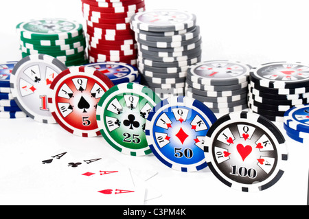 Piled colored chips with four aces isolated on white background Stock Photo