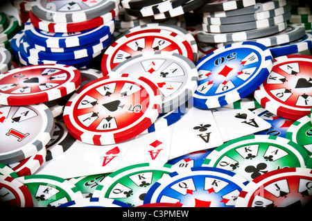 Piled colored chips with four aces isolated on white background Stock Photo