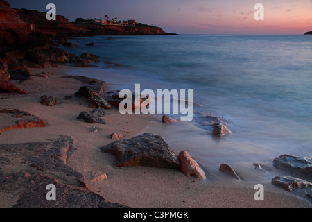 Beach of Cala Conta at sunset, Ibiza, Spain Stock Photo