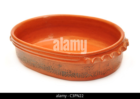 old clay ceramic pot, shaped rounder at the bottom, and more narrow at the top. Isolated on white background. Stock Photo