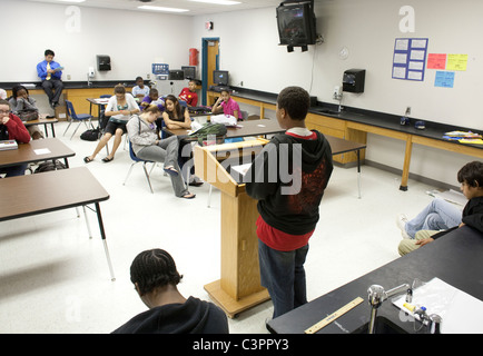 African-American boy speaks in front of students during mock trial in middle school social studies class in Pflugerville Texas Stock Photo