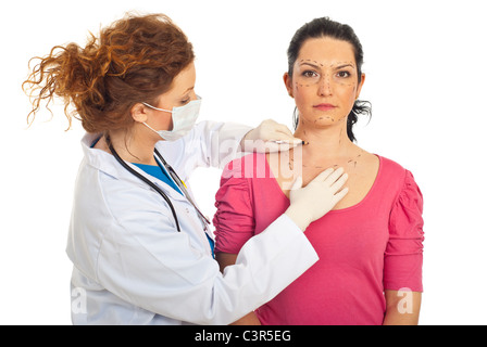 Plastic doctor woman with protective mask drawing woman face and preparing for surgery isolated on white background Stock Photo