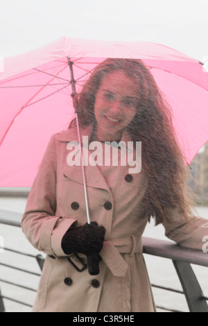 Young woman with umbrella in rain Stock Photo