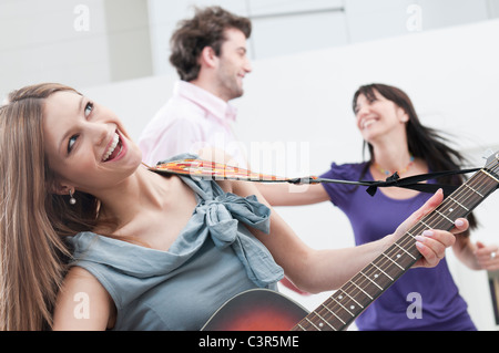 Singing and playing guitar Stock Photo