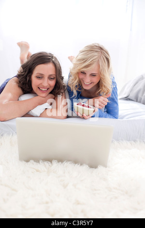 Germany, Leipzeg, Young women watching a movie on laptop Stock Photo