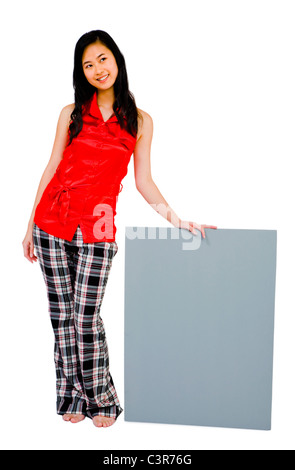 Young woman showing a placard and smiling isolated over white Stock Photo