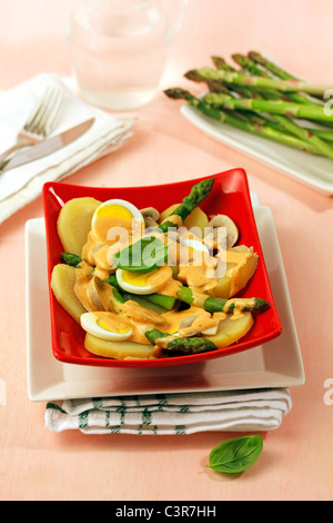 Potato salad with asparagus and  mushrooms. Recipe available. Stock Photo