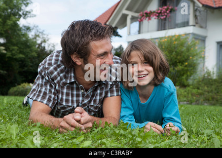 Germany, Munich, Father and son (10-11 Years) in garden, smiling Stock Photo