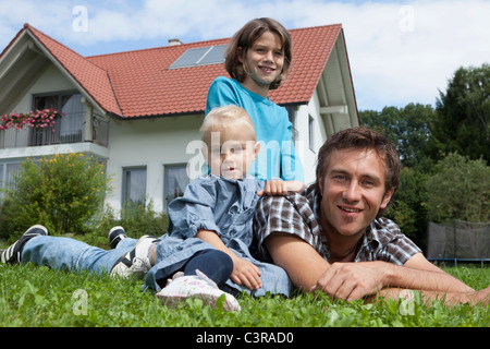 Germany, Munich, Father with children in garden Stock Photo