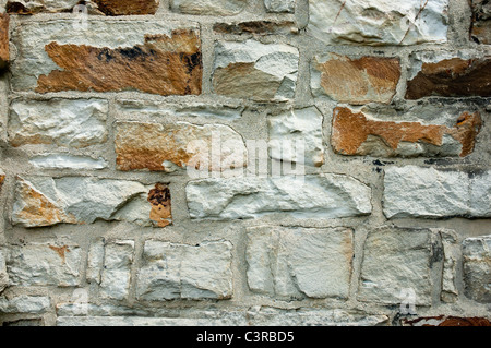 Old stone wall with gray and brown bricks. Outside wall from a little church in Germany. Stock Photo