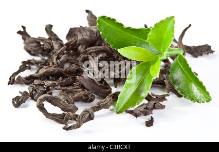 Heap of dry tea with green tea leaves isolated on a white background. Stock Photo