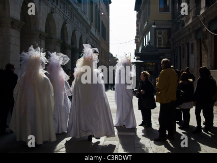 Costumed revelers pose for tourists Stock Photo