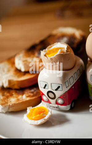 Breakfast - two boiled eggs in VW Camper van egg cups with toast Stock Photo