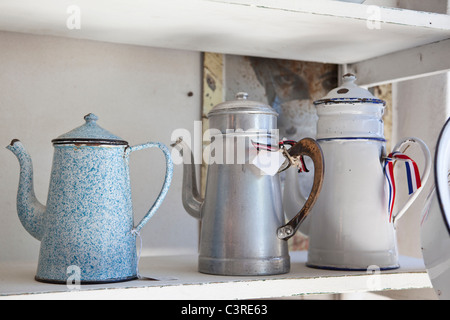 Old emaile Coffecans on a shelf Stock Photo