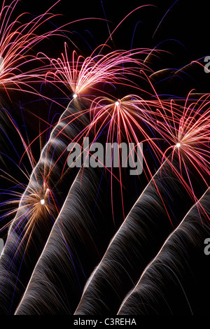 Fireworks exploding against dark night sky Stock Photo