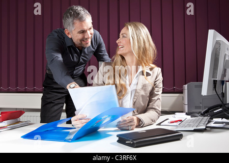 Businesspeople at desk with documents Stock Photo