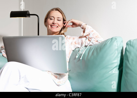 Middle aged woman using laptop Stock Photo