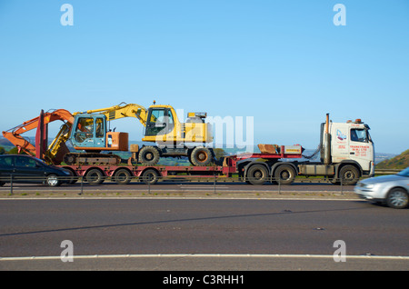 Diggers on a flatbed lorry on the M62 motorway. Stock Photo