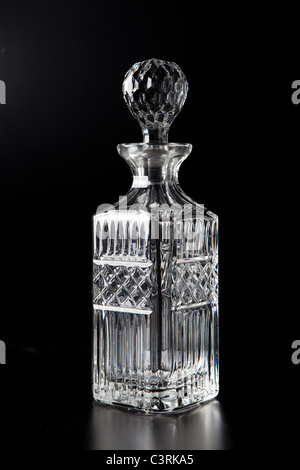 A Scotch decanter on a black background. Stock Photo